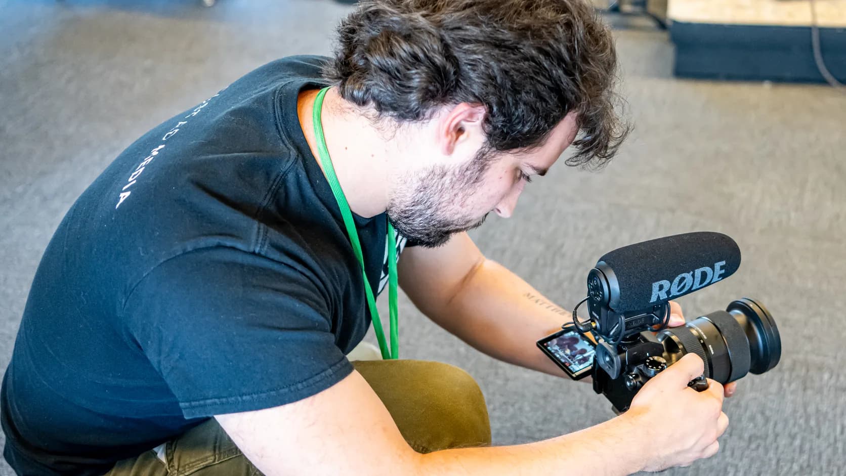 A Kolstad Media filmmaker down low lining up a shot on location