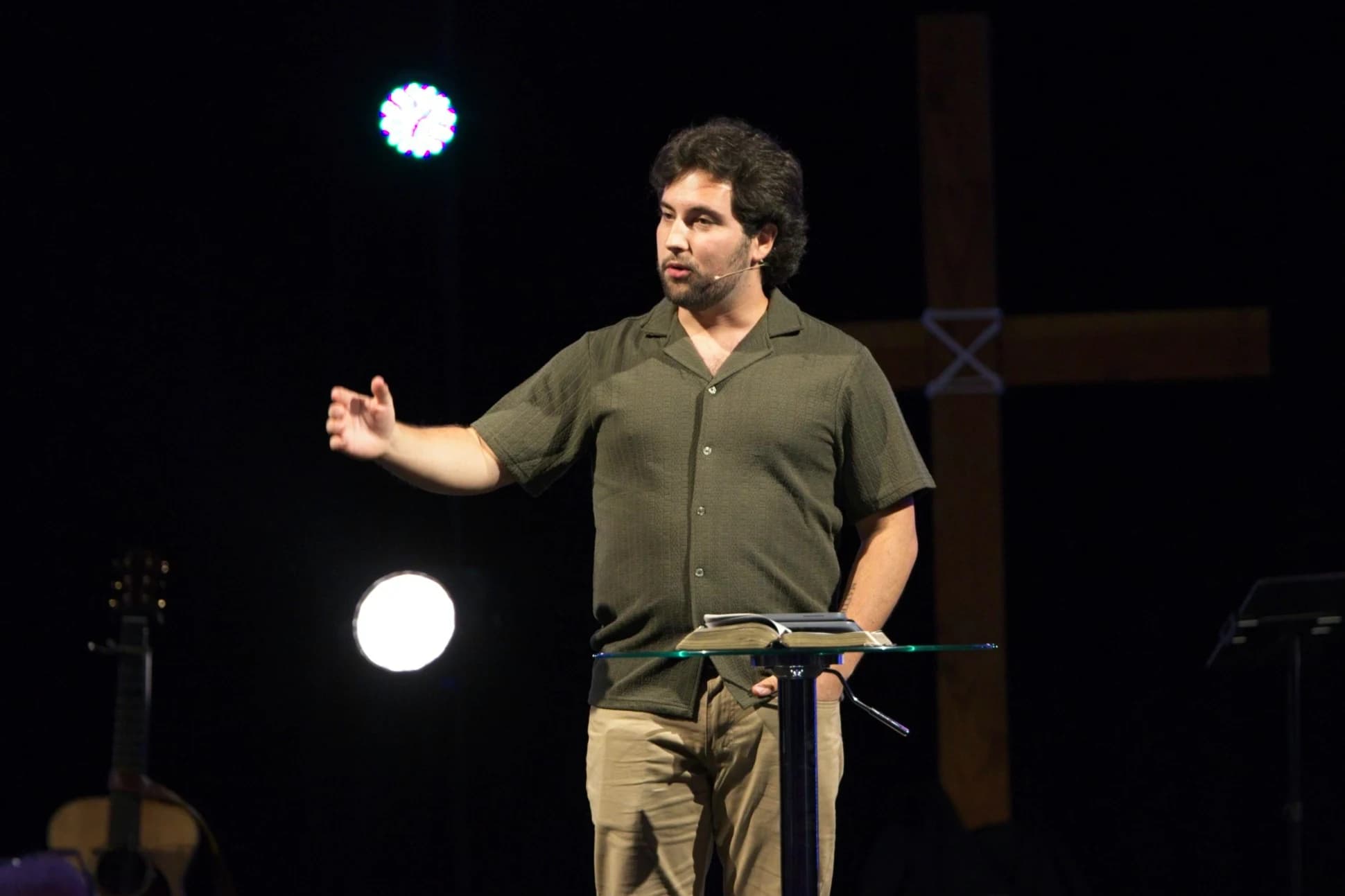 Caleb Kolstad preaching at Westside Community Church with an open Bible